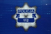 Policyjna odznaka - Gwiazda na niebieskim tle. Pod napisem Policja numer alarmowy 112