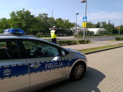 Policjant ruchu drogowego sprawdza oznakowanie w rejonie szkoły